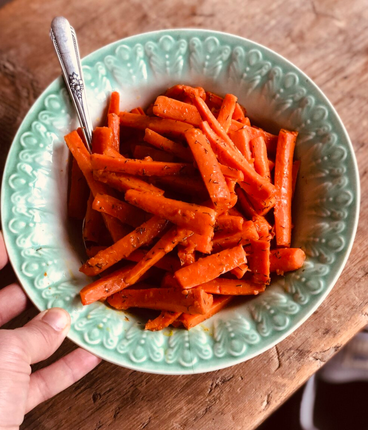 dill buttered carrots in a blue bowl