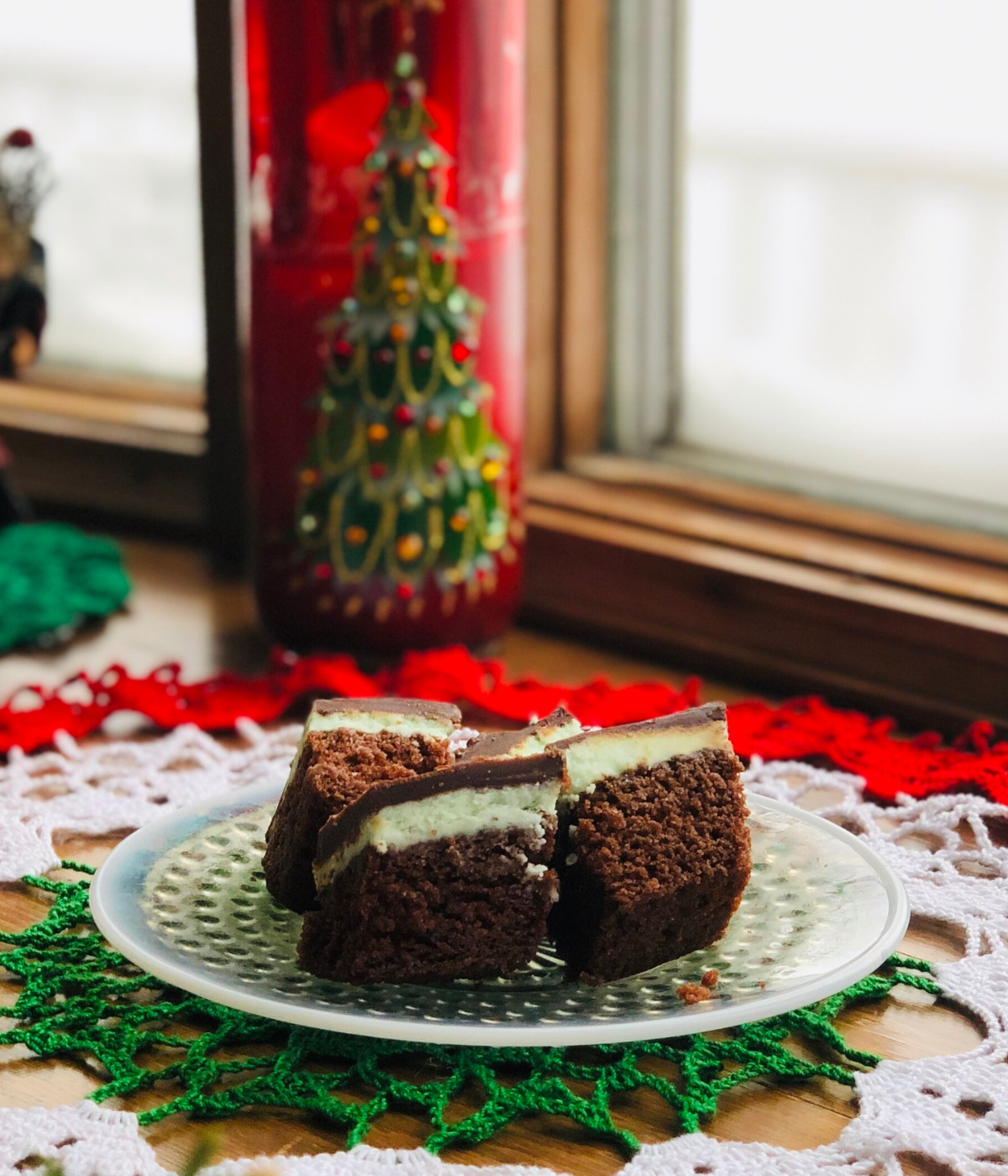 French creme chocolate mint bars on a plate on a christmas themed table