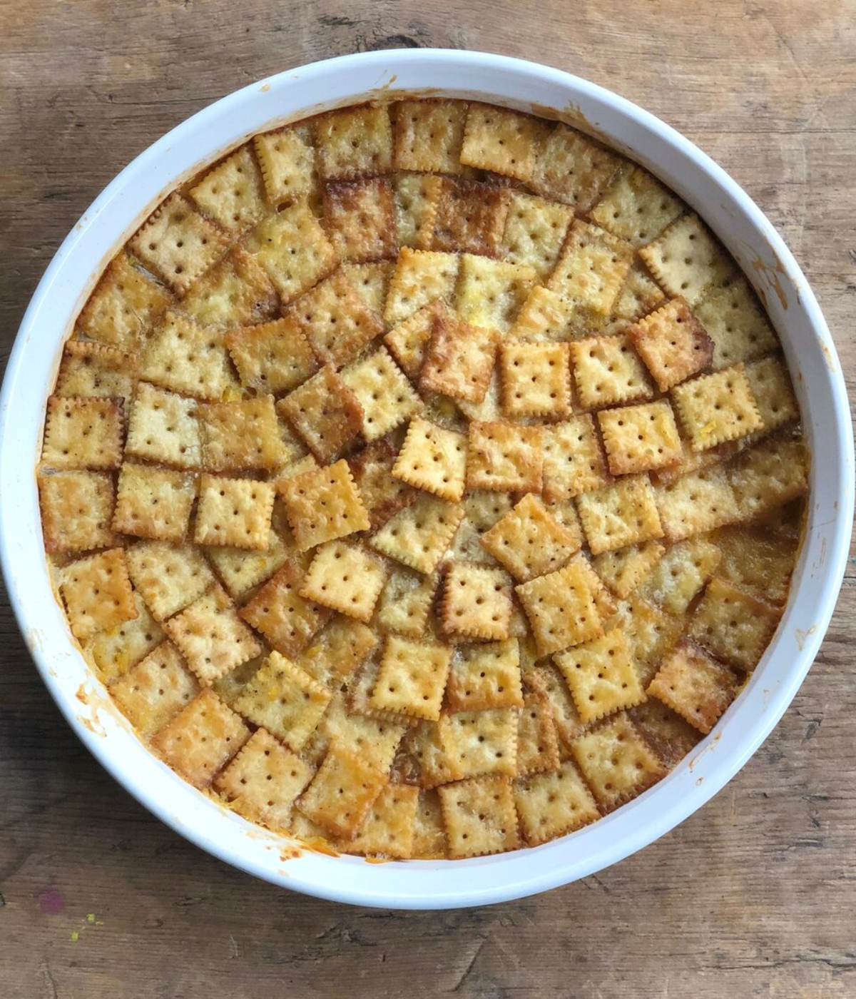 overhead image of the scalloped corn dish topped with saltine crackers