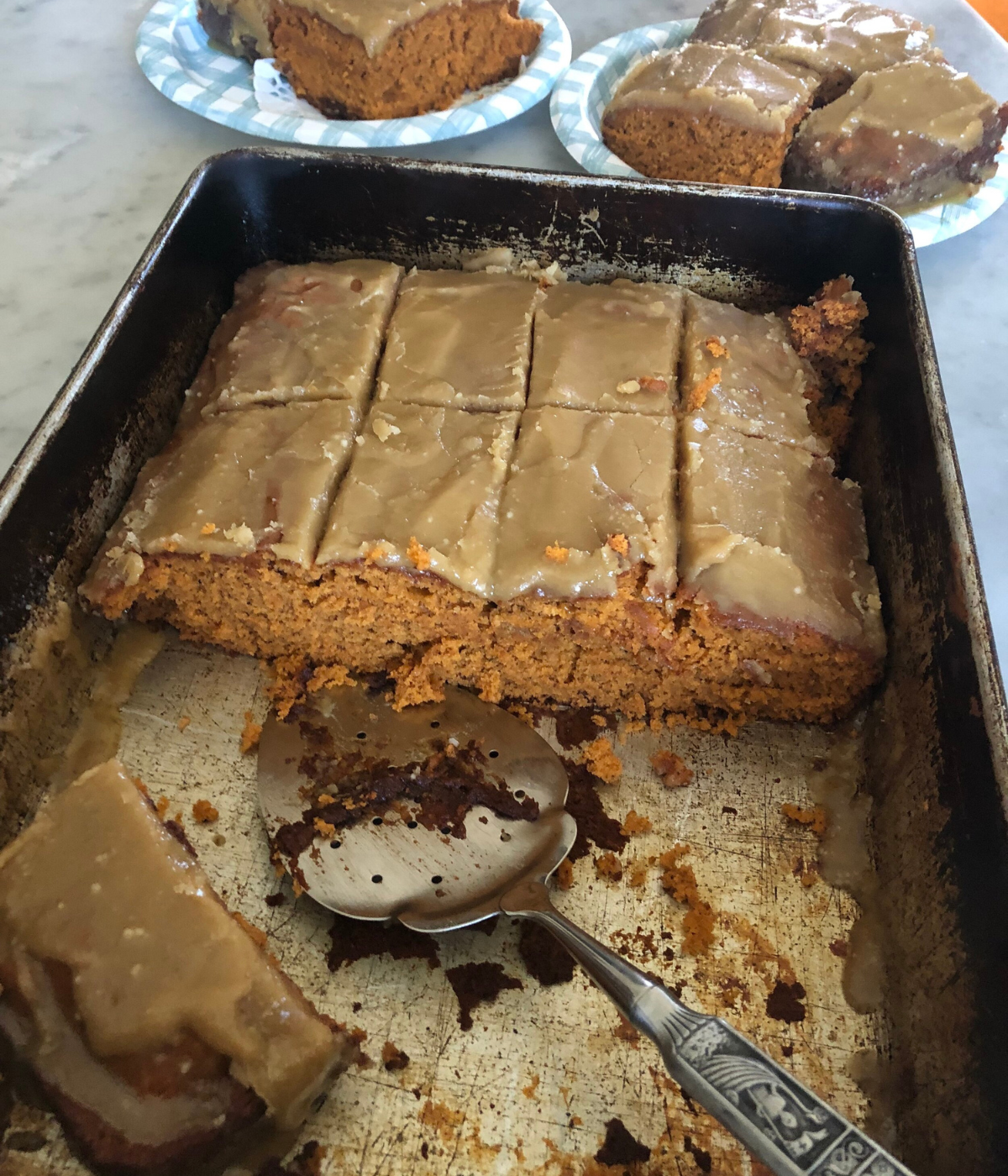 A pan of tomato soup spice cake cut down the middle