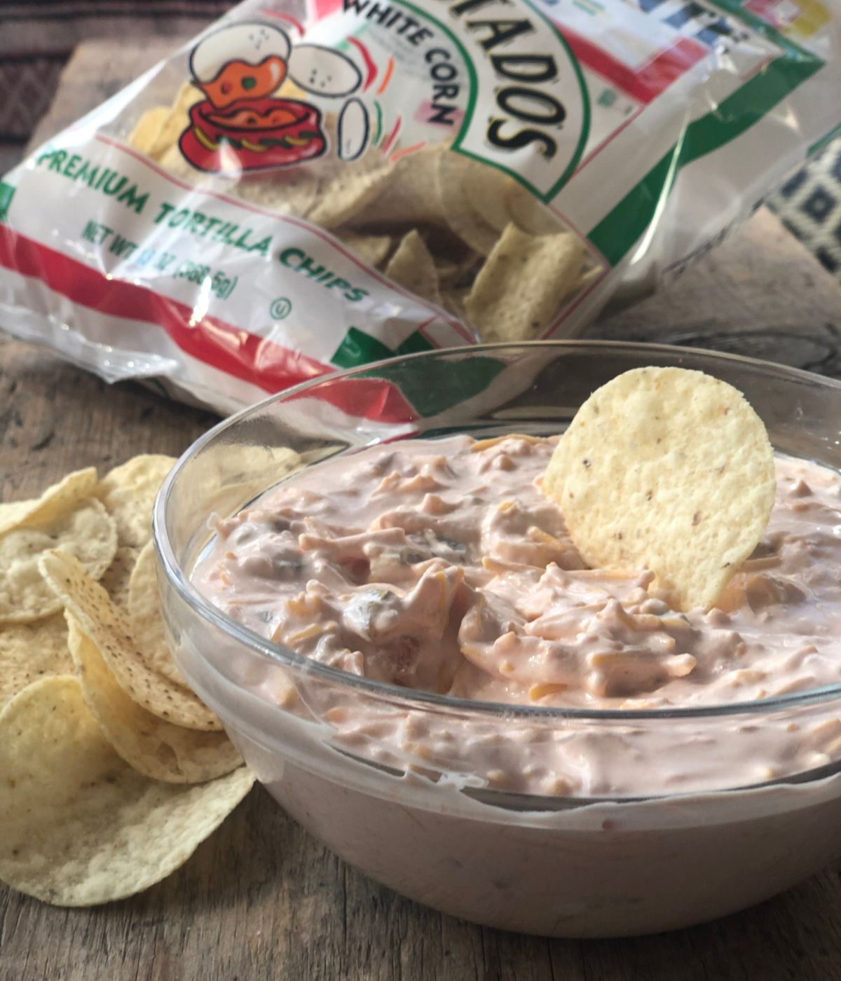 Sue's dip in a glass bowl next to a bag of chips