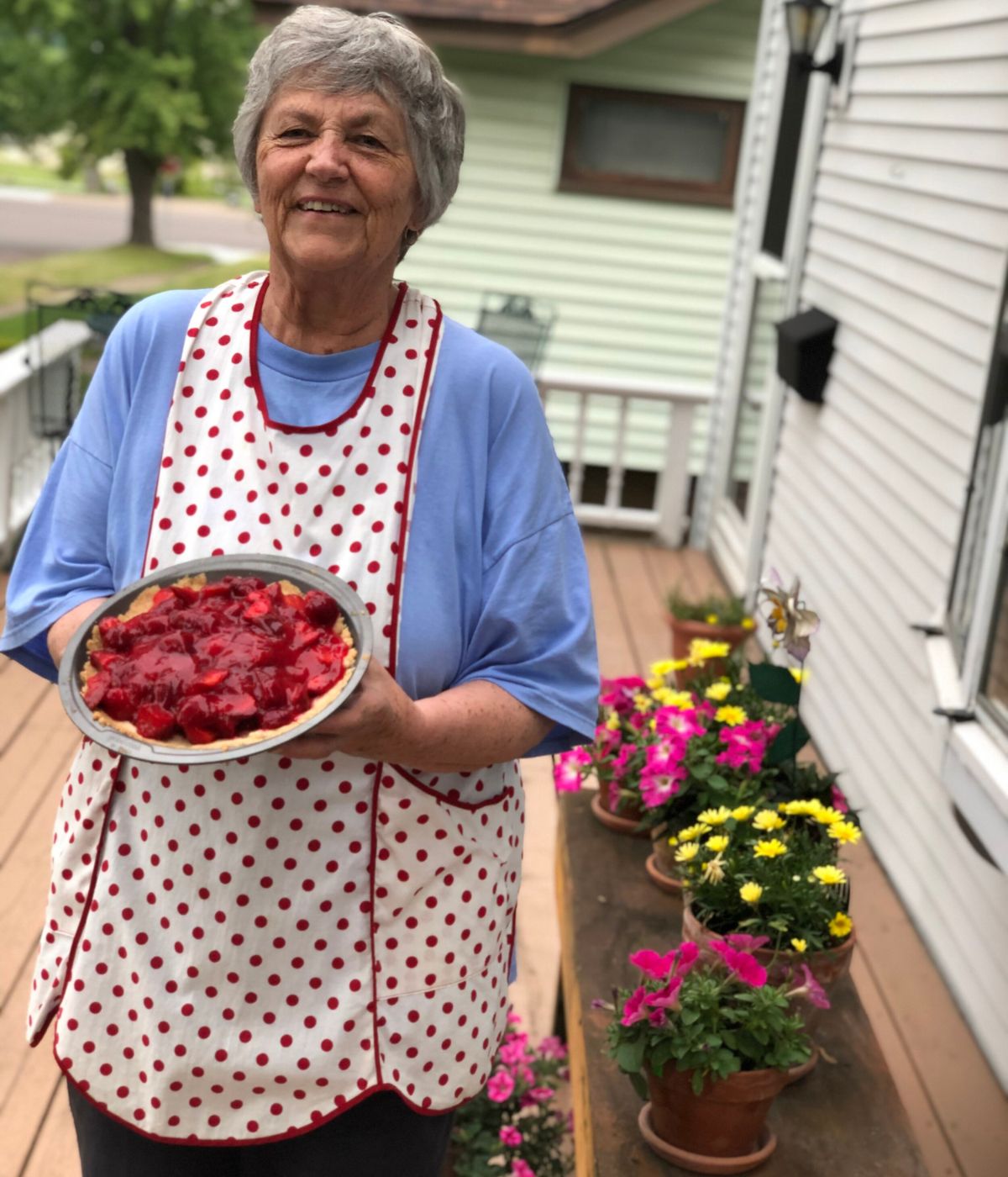 A woman holding a pie featuring the super simple pie crust